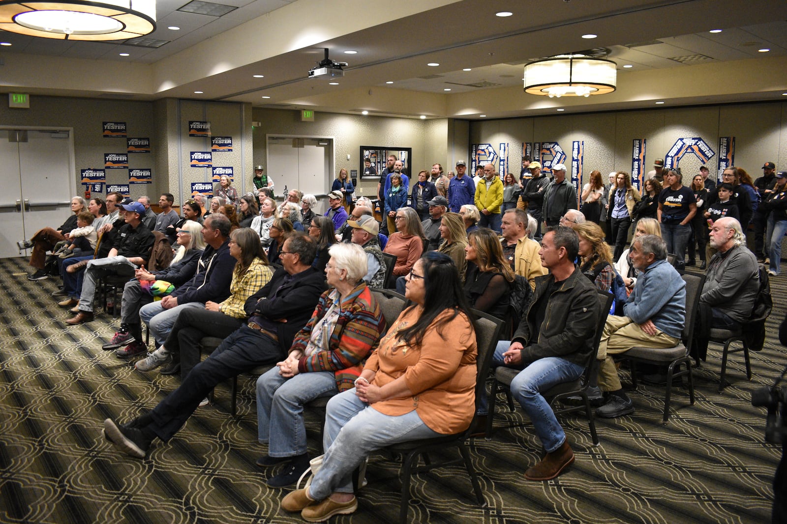 Supporters of U.S. Sen. Jon Tester, a Montana Democrat, are seen during a campaign rally for the three-term incumbent lawmaker in a hotel ballroom, Oct. 25, 2024, in Bozeman, Mont. (AP Photo/Matthew Brown)