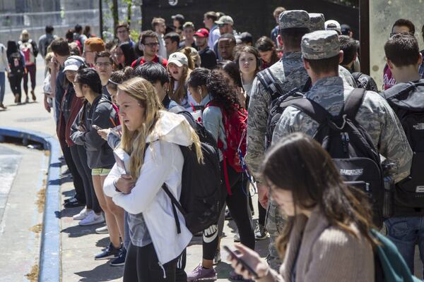 University of Georgia students wait for buses at the Tate Student Center bus stop on the University of Georgia campus in Athens, Georgia in this AJC file photo. 