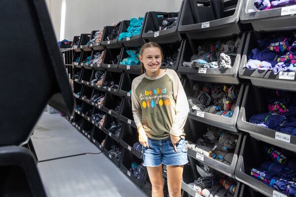 Jordyn Moore helps package T-shirts, pens and stickers at her family's business in Cumming. PHIL SKINNER FOR THE ATLANTA JOURNAL-CONSTITUTION