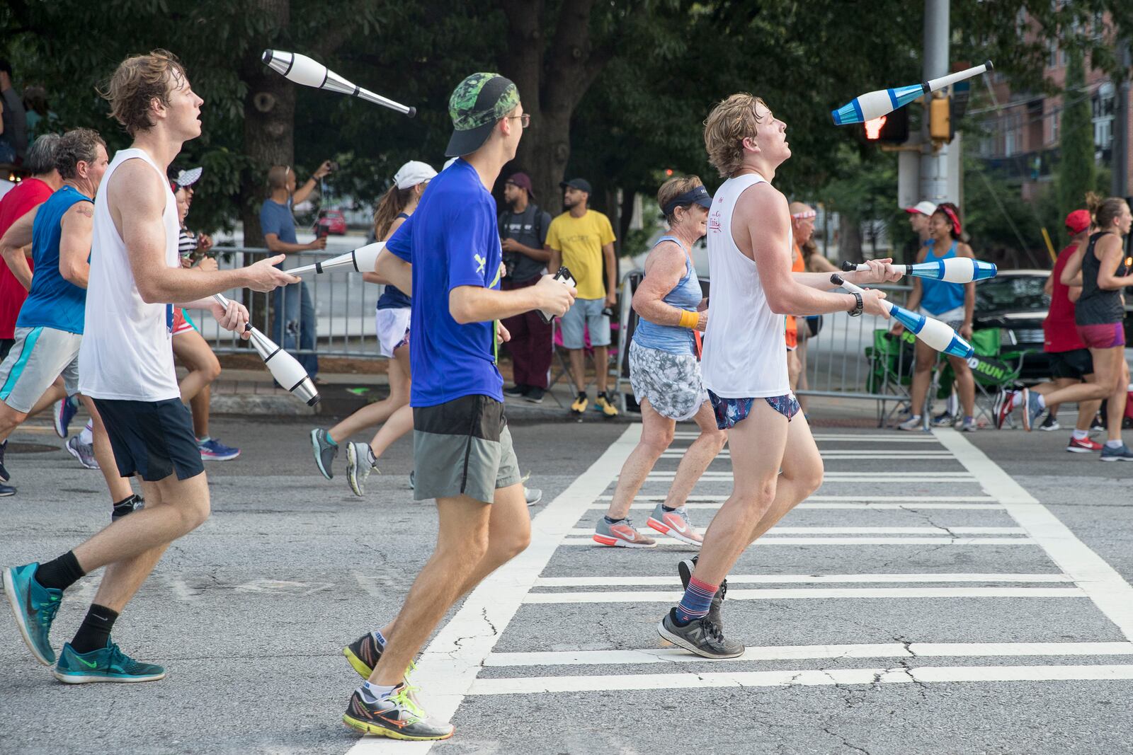 07/04/2018 -- Atlanta, GA -A group of juggling men participate during the 49th running of the AJC Peachtree road race near Piedmont Park, Wednesday, July 4, 2018.  ALYSSA POINTER/ALYSSA.POINTER@AJC.COM