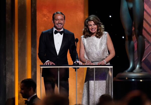 Tim McGraw, left, and Faith Hill present the award for outstanding performance by a male actor in a drama series at the 28th annual Screen Actors Guild Awards at the Barker Hangar on Sunday, Feb. 27, 2022, in Santa Monica, Calif. (AP Photo/Chris Pizzello)