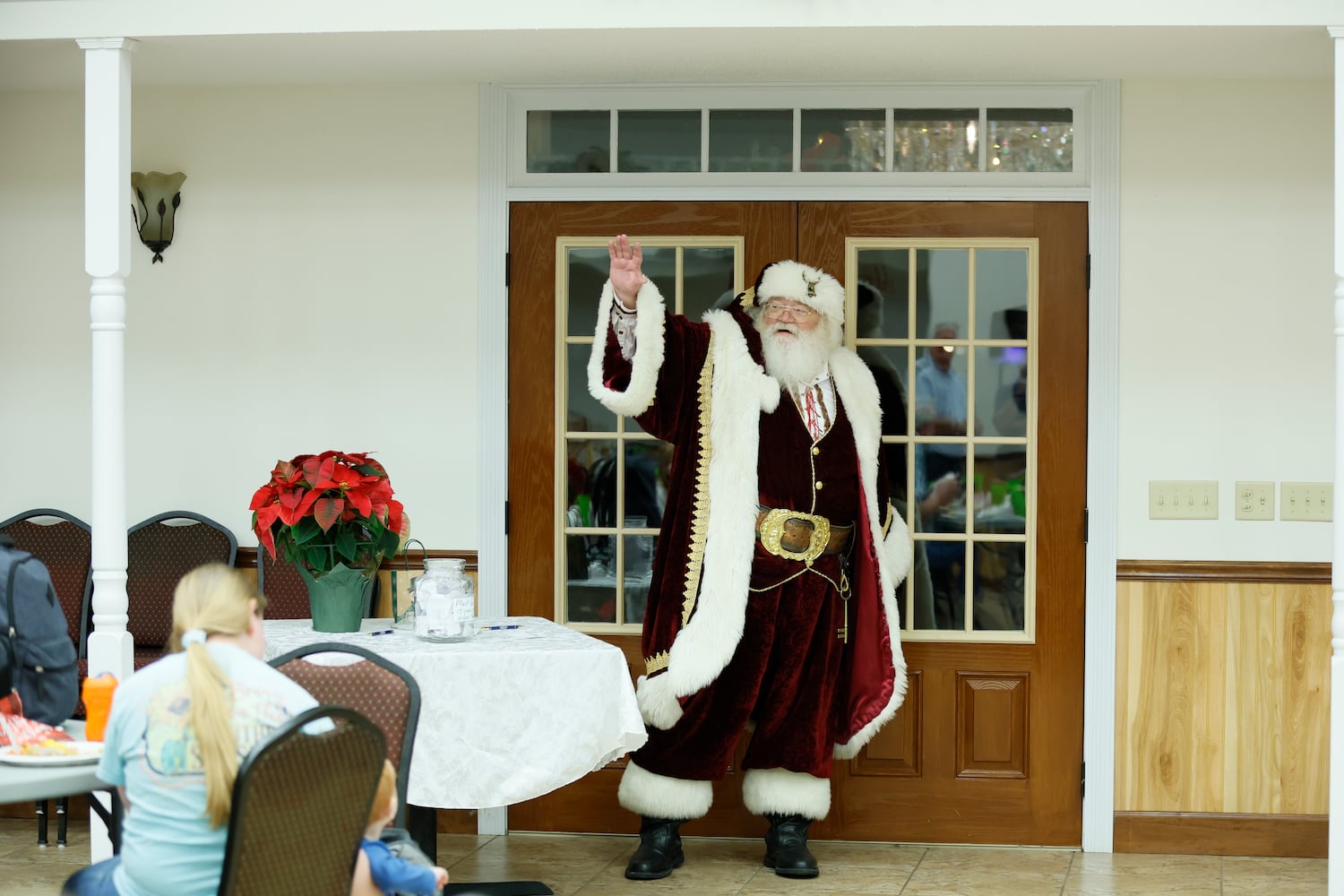 Woodrow "Willy" Smith enters the community center during a Christmas dinner for the residents of Santa Claus, and Smith participates in the same community as Santa during a Christmas tree lighting in November.
 Miguel Martinez / miguel.martinezjimenez@ajc.com