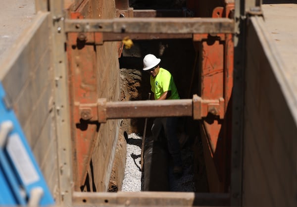 DeKalb County contractors work to replace a twelve inch sanitary main sewer line nine feet below the surface of Emerald Castle Drive, Wednesday, September 21, 2022, in Decatur. The one-year anniversary of Dekalb County’s new consent decree to fix it’s long-neglected sewer system. (Jason Getz / Jason.Getz@ajc.com)