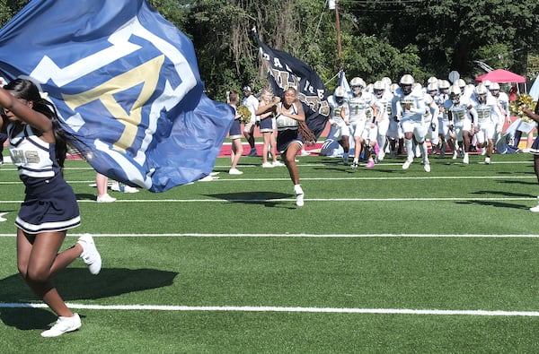 The Apalachee High School football team takes the field led by the cheer squad in their game against Clarke Central on Saturday Sept. 28, 2024 in Georgia.

 Nell Carroll for The Atlanta Journal-Constitution