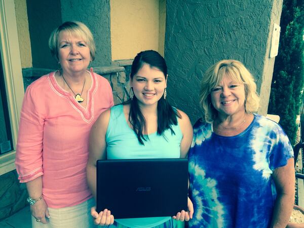 YWCA of Northwest Georgia Executive Director, left, and supporter Kim Gresh, right, surprised Felicia with a laptop that she can use for work and for online classes. Photo: Jennifer Brett