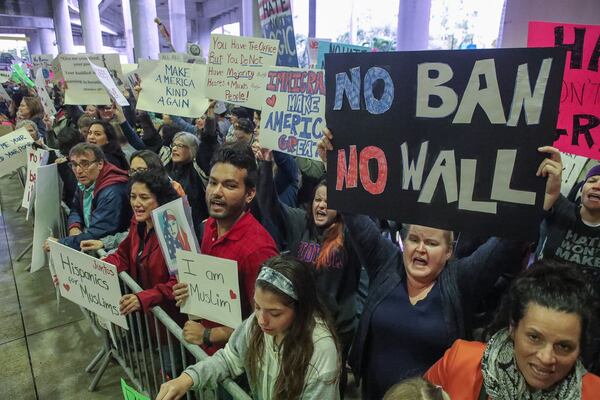 People protest against President Trump's ban on immigrants returning from a list of seven countries at the Palm Beach International Airport, Sunday, January 29, 2017. Damon Higgins / Daily News