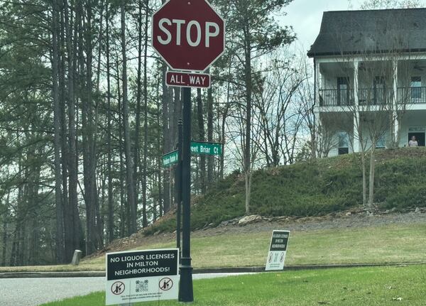 Neighbors who oppose an alcohol license for Jim and Daryn Rosenberger's farm winery have lined the neighborhood with opposition signs.