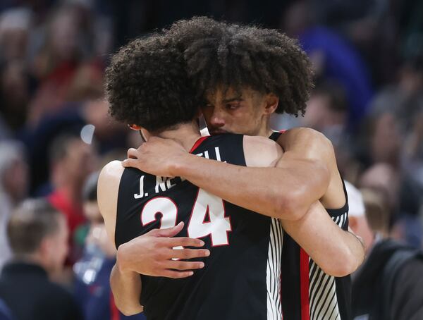 Georgia forward Asa Newell, right, hugs teammate Jaden Newell (24) after their loss to Gonzaga in the first round of the NCAA college basketball tournament, Thursday, March 20, 2025, in Wichita, Kan. (AP Photo/Travis Heying)