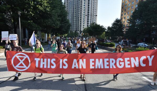 Protesters march on Peachtree Road near Buckhead MARTA transit station during Southeast Climate Strike and Rebellion on Friday, September 27, 2019. 