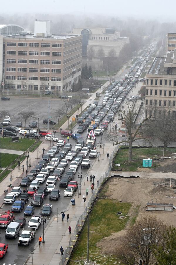 Cars aren't moving at the corner of West Allegan Street and North Capitol Avenue as protestors, from their cars and on foot, surround the State Capitol during "Operation Gridlock" in Lansing, Mich. on Wednesday, April 15, 2020. (Daniel Mears/ The Detroit News/TNS)