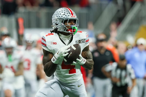 Ohio State wide receiver Jeremiah Smith (4) makes a 56-yard reception during the fourth quarter against the Notre Dame in the 2025 National Championship at Mercedes-Benz Stadium, Monday, Jan. 20, 2025, in Atlanta. Ohio State won 34-23. (Jason Getz / AJC)