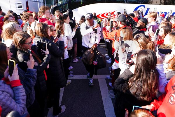 Georgia running back Zamir White is greeted by a large crowd of fans as he and his teammates return to the Georgia campus, Tuesday, Jan. 11, 2022, in Athens, Ga., after defeating Alabama in the College Football Championship NCAA college football game. (AP Photo/John Bazemore)