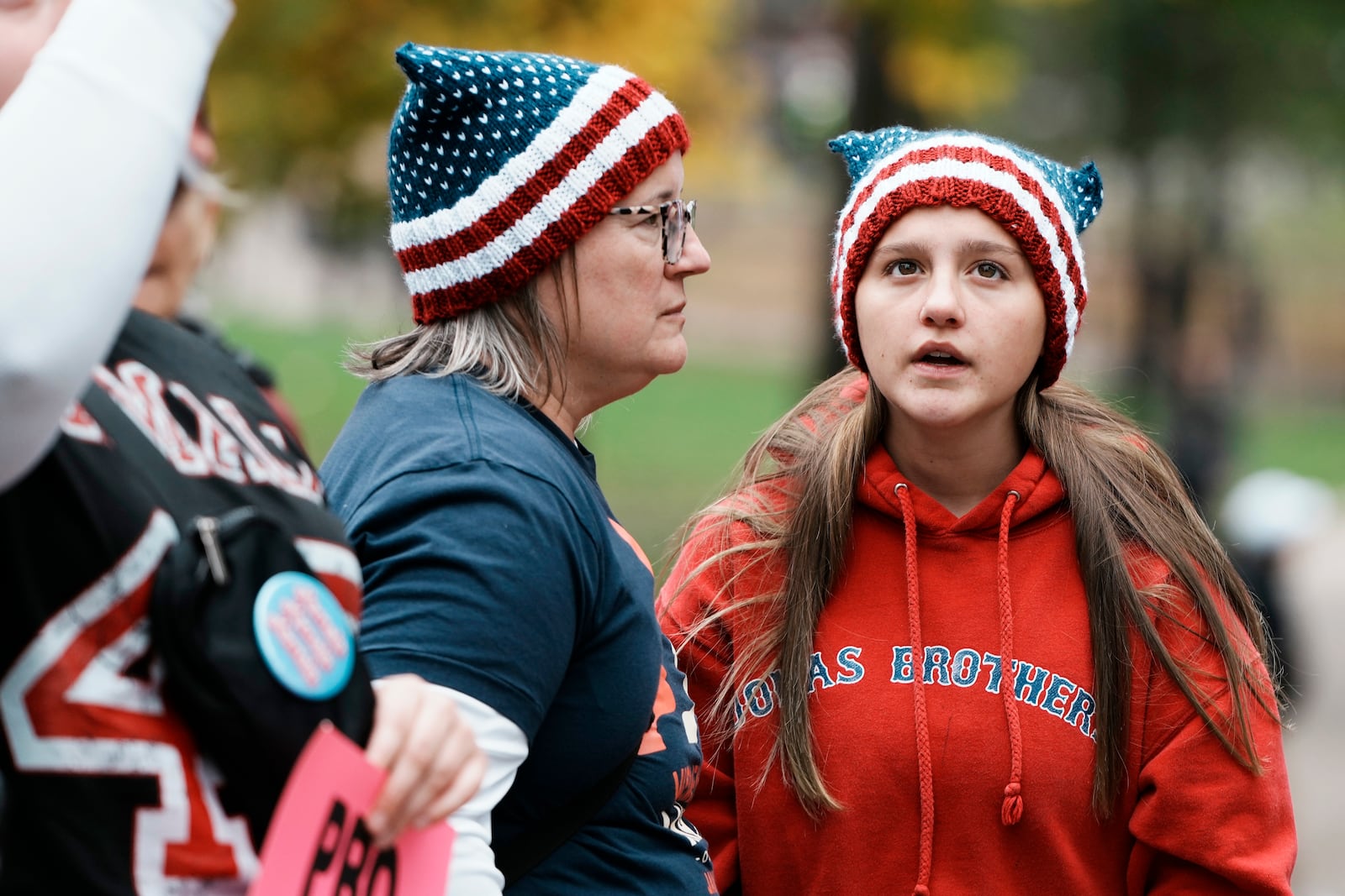 Ami Faria and her daughter Amelia, of Exeter, N.H., attend the National Women's March on Boston Common, Saturday, Nov. 2, 2024, in Boston. (AP Photo/Michael Dwyer)