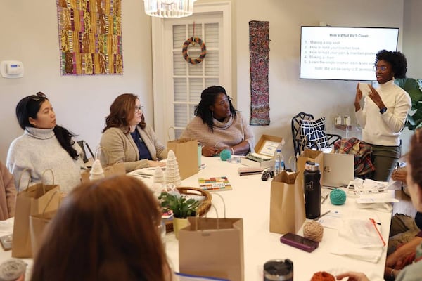 Judah David Creations owner Darice Oppong shows team members from Resilience Georgia a single crochet stitch in her beginner crochet class on Wednesday, Dec. 11, 2024, at The Web in Macon, Georgia. (Photo Courtesy of Katie Tucker/The Telegraph)