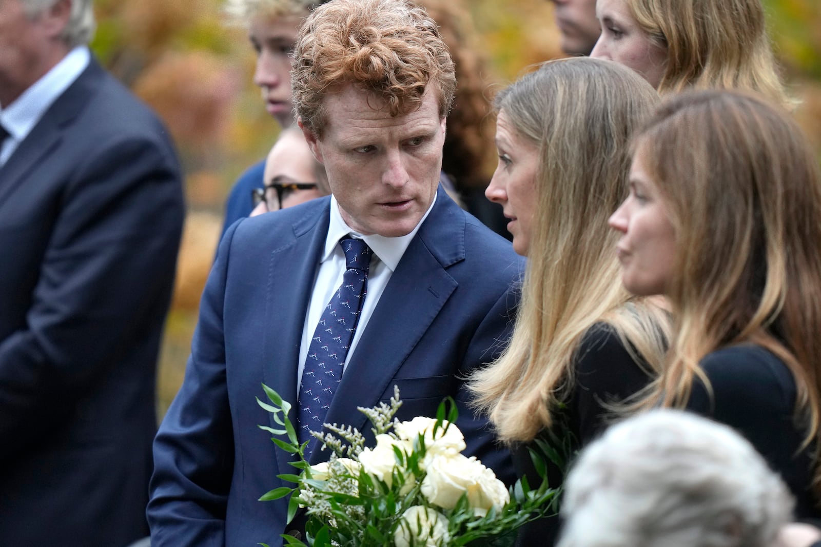 Joseph Kennedy III, center, grandson of Ethel Kennedy, speaks to his wife Lauren Birchfield, second right, following funeral services for Ethel Kennedy at Our Lady of Victory church, Monday, Oct. 14, 2024, in Centerville, Mass. (AP Photo/Steven Senne)