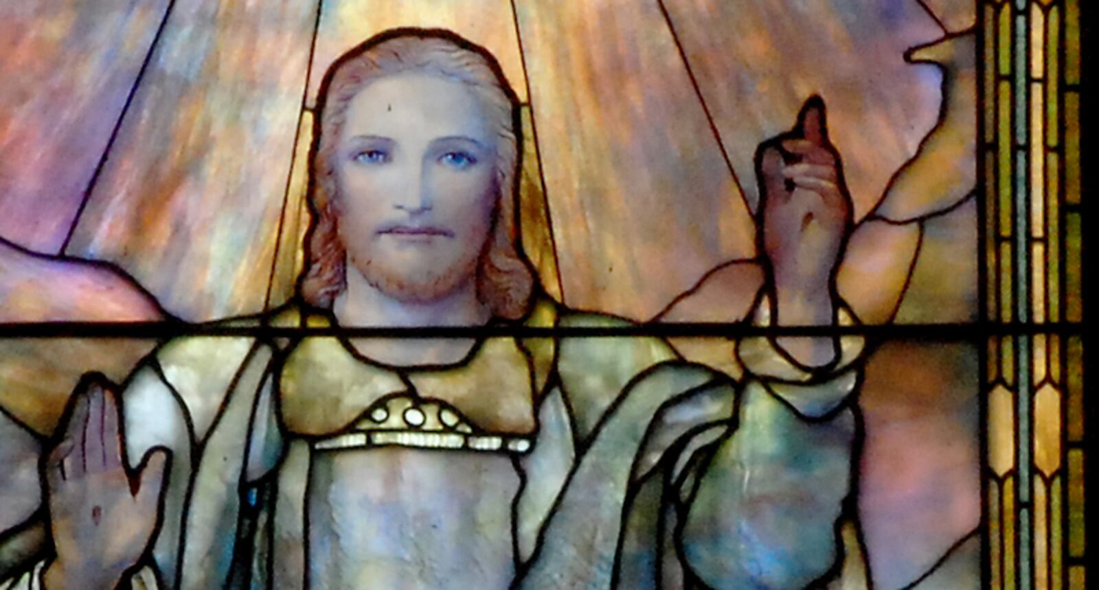 A detail of the "Ascension" window at First Presbyterian Church of Atlanta, showing the face and hands of Jesus.