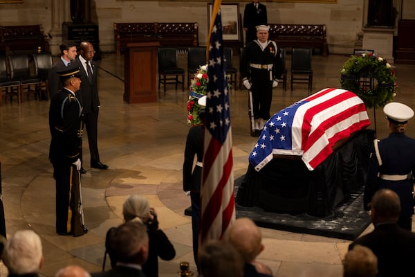 U.S. Senators Raphael Warnock, D-Ga, and U.S. Sen. Jon Ossoff, D-Ga., pay their respects as former President Jimmy Carter lies in state inside the rotunda of the U.S. Capitol Building in Washington, DC on Tuesday, January 7, 2025.