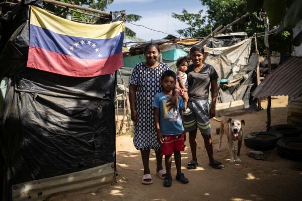 Nelly Mengual, from left, poses with her daughter Luciane Mengual and her grandchildren in the Villa del Sur neighborhood on the outskirts of Riohacha, Colombia, Tuesday, Feb. 4, 2025. (AP Photo/Ivan Valencia)