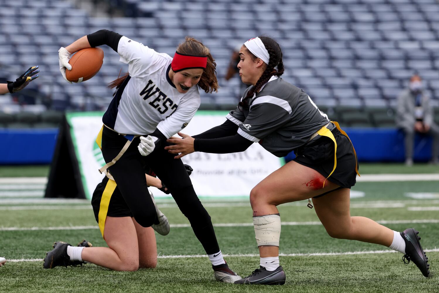 West Forsyth defensive back Haylee Dornan (1) is tackled by Hillgrove's Kaylan Sacus (21) after Dornan made an interception during the Class 6A-7A Flag Football championship at Center Parc Stadium Monday, December 28, 2020 in Atlanta, Ga.. JASON GETZ FOR THE ATLANTA JOURNAL-CONSTITUTION