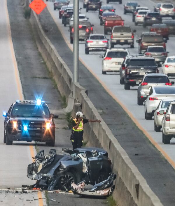 A fatal crash blocked all northbound lanes of Ga. 400 at Holcomb Bridge Road in Roswell last June. A spokesperson for the Governors Highway Safety Association says that the U.S. is experiencing "a traffic safety crisis," and that "we must do more of everything that works to better protect everyone on the road, both inside and outside a vehicle." (John Spink / John.Spink@ajc.com)