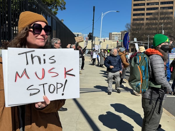 Jennifer Holbach protests in front of the Georgia Capitol in Atlanta on Monday, Feb. 17, 2025.