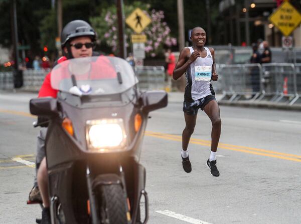 7/4/2019 -- Atlanta, Georgia -- A front runner in the men’s elite foot race pushes down the final stretch of 10th Street NE during the AJC Peachtree Road Race in Atlanta, Thursday, July 4, 2019. (Alyssa Pointer/alyssa.pointer@ajc.com)