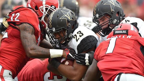 Georgia Bulldogs defensive back Juwuan Briscoe tries to strip the ball from Vanderbilt Commodores running back Khari Blasingame during the 4th quarter on Saturday, Oct. 15, 2016,  at Sanford Stadium in Athens.