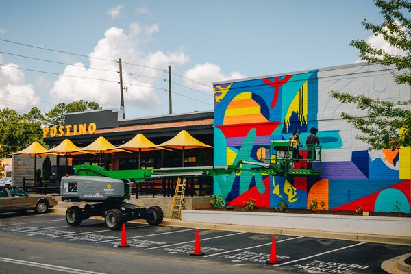 Murals from local artist Wolfdog can be seen on the exterior walls of Postino WineCafe.