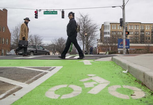 Pedestrians cross the intersection of Commerce Drive and Swanton Way in downtown Decatur, Thursday, January 23, 2020. The city renovated the sidewalks adding enough space for a bicycle lane in addition to foot traffic. (ALYSSA POINTER/ALYSSA.POINTER@AJC.COM)