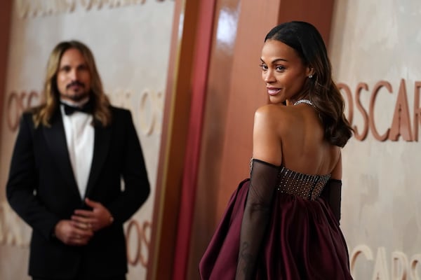 Marco Perego-Saldana, left, and Zoe Saldana arrive at the Oscars on Sunday, March 2, 2025, at the Dolby Theatre in Los Angeles. (Photo by Jordan Strauss/Invision/AP)