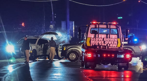 A tow truck prepares to help clear the crash scene following a high-speed pursuit that ended with a Coweta County Sheriff's Office K-9 killed and a deputy injured.