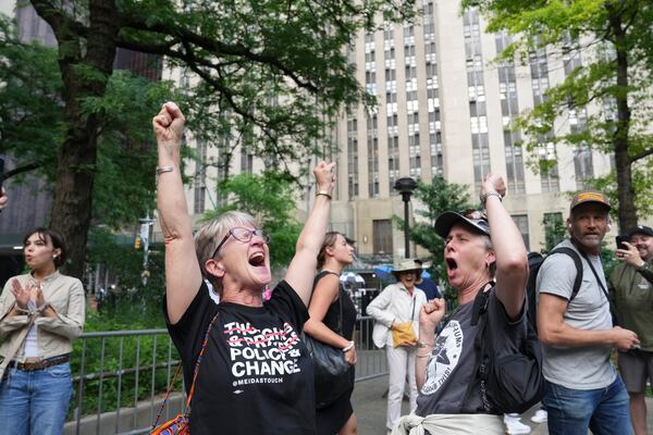 
                        People react to former President Donald Trump being found guilty of all counts in his criminal trial outside the Manhattan Criminal Courthouse in New York, on Thursday, May 30, 2024. Trump has been convicted of falsifying records to cover up a sex scandal that threatened his ascent to the White House in 2016, part of a scheme that prosecutors described as a fraud on the American people. He is the first American president to be declared a felon. (Todd Heisler/The New York Times)
                      