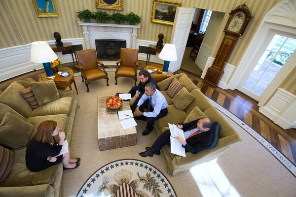 President Barack Obama works with Cody Keenan, rear, the president’s director of speechwriting, Ben Rhodes, the deputy national security adviser, and Jen Psaki, left, director of White House Communications, in the Oval Office of the White House on the eve of his final State of the Union in Washington, Jan. 11, 2016. (Doug Mills/The New York Times)