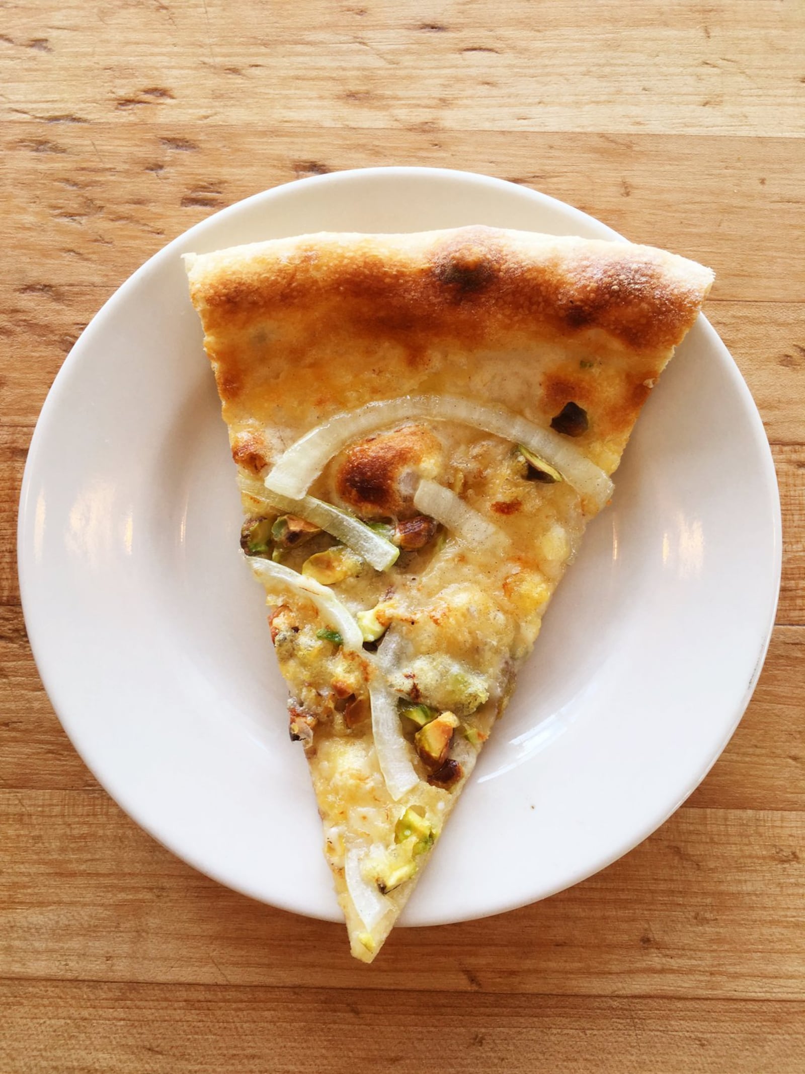 Star Provisions, the retail and counter service space adjoining Bacchanalia, serves pizzas that are neither traditionally Neapolitan nor exactly American in style. The pies sport extra-crisp thin, golden crusts and distinct, subtle flavor combinations. Pictured is the Rosa, with Parmesan, pistachios and red onion. CONTRIBUTED BY WYATT WILLIAMS