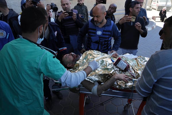 An injured United Nations Mine Action Service (UNMAS) worker is taken into the al-Aqsa Martyrs hospital after an explosion in Deir al-Balah in central Gaza, Wednesday March 19, 2025. (AP Photo/Abdel Kareem Hana)