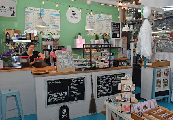 Three Peaches owner Kenda Bauser stands behind the counter at her gelato and coffee shop inside Municipal Market. Chris Hunt for The Atlanta Journal-Constitution