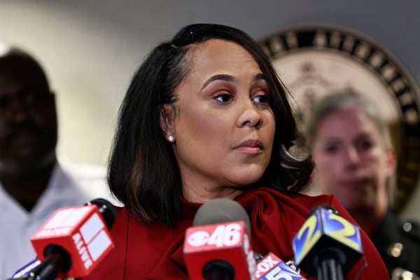 In this photo from  Aug. 29, 2022, surrounded by Fulton County law enforcement officials, District Attorney Fani Willis speaks during a news conference about the RICO indictment in the celebrity home invasion ring. (Natrice Miller/The Atlanta Journal-Constitution/TNS)