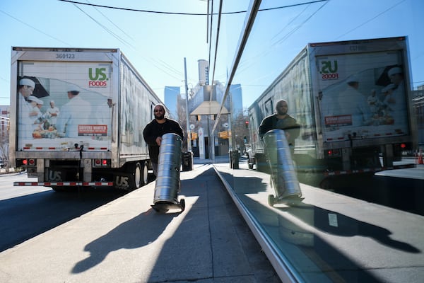 Kris Rivers, with General Wholesale Beer Company, delivers fresh kegs to Max’s Coal Oven Pizzeria in downtown Atlanta in preparation for the college football championship Friday, Jan. 17, 2025.   Ben Gray for the Atlanta Journal-Constitution