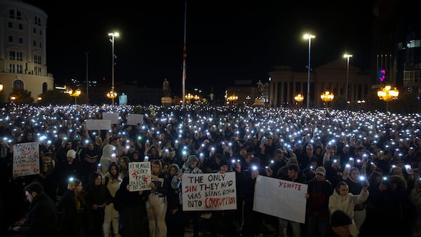 Protesters hold placards as thousands gather in protest for the victims of a massive nightclub fire in the town of Kocani, in Skopje, North Macedonia, Tuesday, March 18, 2025. (AP Photo/Visar Kryeziu)