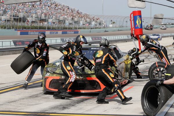 Crew members for Chase Briscoe perform a pitstop during a NASCAR Cup Series auto race at Homestead-Miami Speedway in Homestead, Fla., Sunday, March 23, 2025. (AP Photo/Terry Renna)