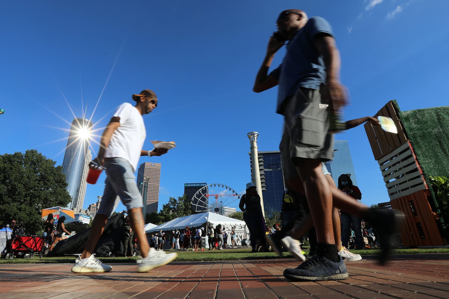 Crowds cross the Centennial Park to move from one stage to another to see the variety of artists that perform at the ONE Musicfest. The organization canceled the event last year because of COVID-19. Sunday, October 10, 2021. Miguel Martinez for The Atlanta Journal-Constitution