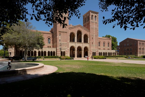 FILE - Children play outside Royce Hall at the University of California, Los Angeles, campus in Los Angeles, Aug. 15, 2024. (AP Photo/Damian Dovarganes, File)