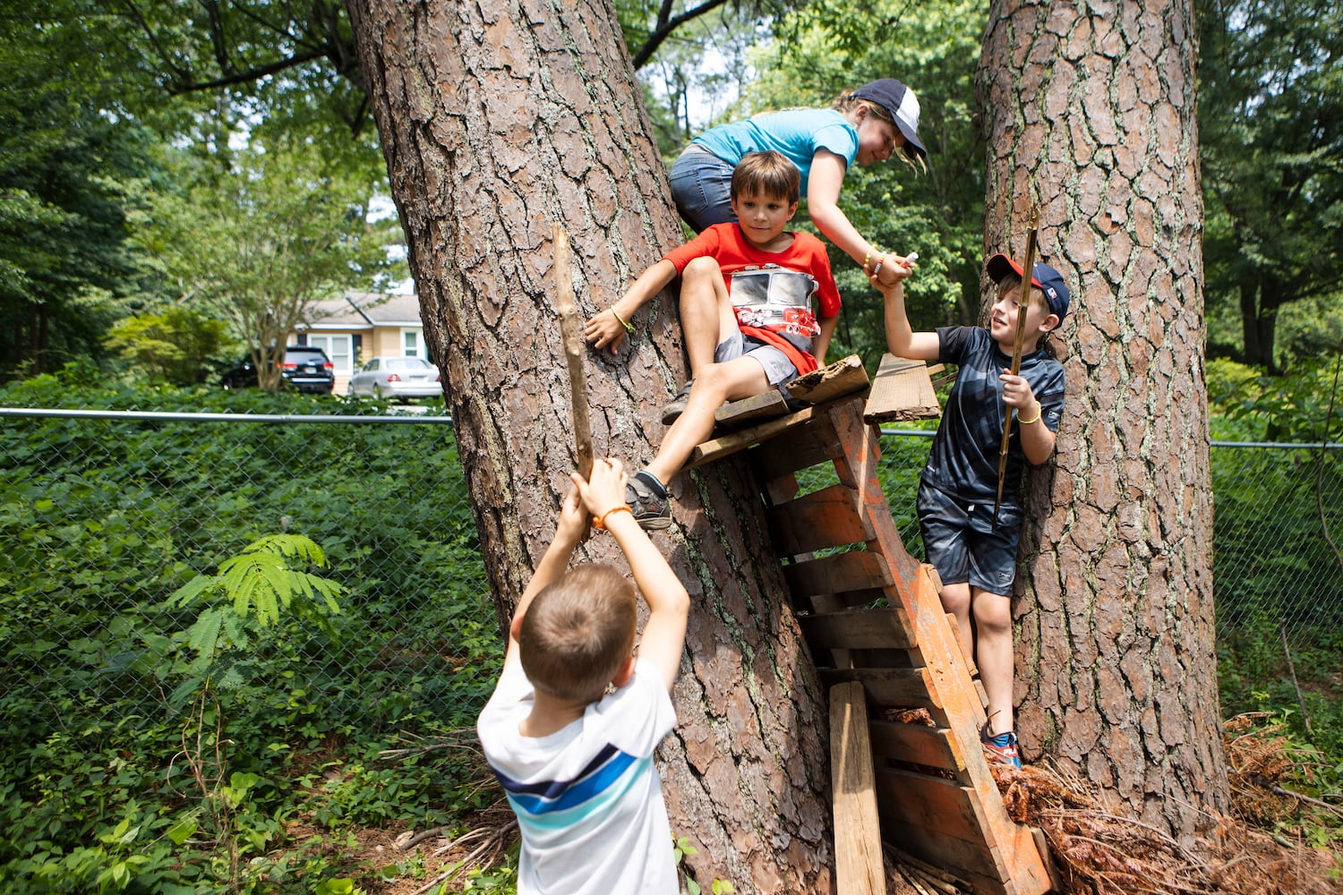 Summer campers play in their fort at Our Giving Garden on Wednesday, June 7, 2023, in Mableton, Georgia. Our Giving Garden is a nonprofit community garden that donates fresh produce to families without access to it. CHRISTINA MATACOTTA FOR THE ATLANTA JOURNAL-CONSTITUTION.