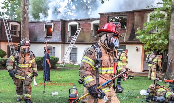 DeKalb firefighters work to put out a fire at the Rue Fontaine condos in this July 2018 file photo. JOHN SPINK / JSPINK@AJC.COM