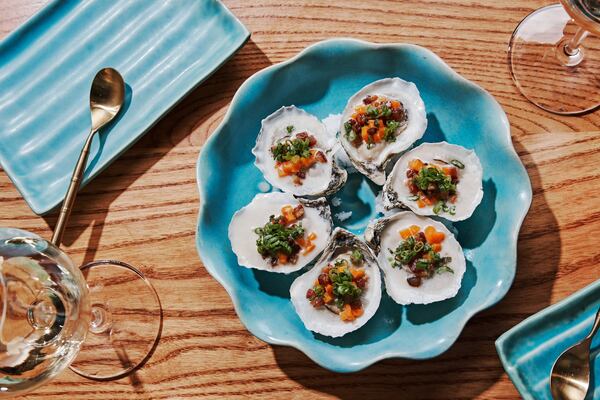 At Talat Market, oysters topped with bacon and sweet potatoes get nice and smoky on a grill made by Chris Demant. (Courtesy of Andrew Lee Thomas/Talat Market)