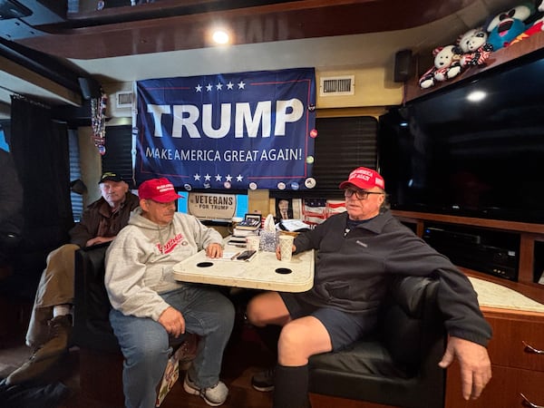 Wallace Mathis, Lenny Solomon and Danny Hamilton sit in one of the seven buses packed with Donald Trump supporters that traveled overnight from Atlanta to an RV park in suburban Maryland. (Greg Bluestein/AJC)