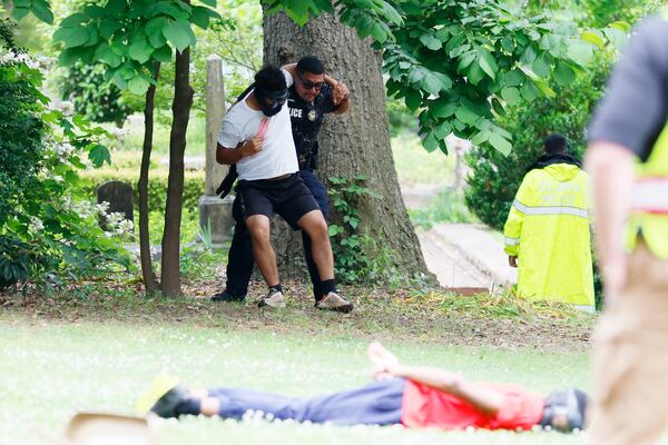 (POLICE TRAINING) A member of the Atlanta Police Department is evacuating an individual playing the victim role as part of an active shooting drill at the Oakland Cemetery on Thursday, May 18, 2023.
Miguel Martinez /miguel.martinezjimenez@ajc.com