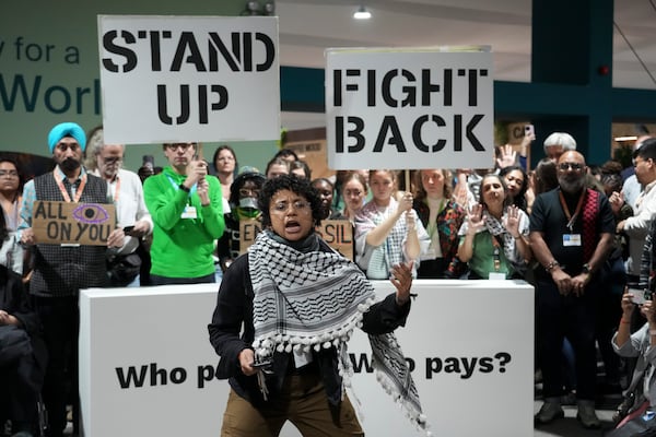 Activists participate in a demonstration for climate finance at the COP29 U.N. Climate Summit, Saturday, Nov. 23, 2024, in Baku, Azerbaijan. (AP Photo/Sergei Grits)