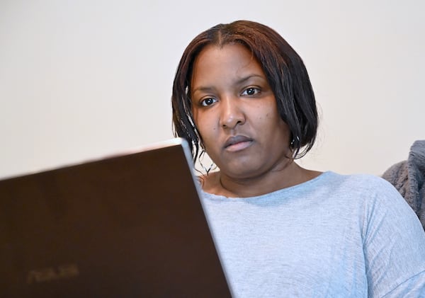 Tamekia Bell prepares for her application for a permanent job while also working a temporary seasonal job at home in Smyrna on Thursday, Nov. 12, 2020. (Hyosub Shin / Hyosub.Shin@ajc.com)