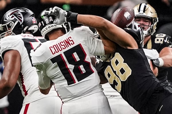 New Orleans Saints defensive end Payton Turner (98) hits Atlanta Falcons quarterback Kirk Cousins (18) causing a fumble during the first half of an NFL football game, Sunday, Nov. 10, 2024, in New Orleans. (AP Photo/Gerald Herbert)